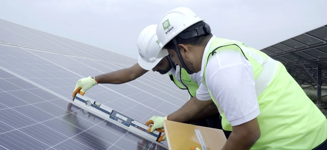Technicians checking the alignment of installed solar panels